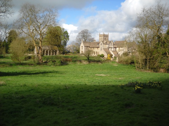 Horton Court beside the parish church on a spring line at the foot of the Cotswold escarpment. An ancient settlement location, the Iron Age Horton Camp hillfort lies on the ridge top behind the camera location. The Tudor loggia can be seen on the left with the terraces of the Tudor garden stepping down to the stream and the line of medieval fishponds beside the house.